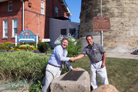 Fred E. Woods, executive director of the Foundation (left) and Fairport Harbor Mayor Frank Sarosy (right) shake hands over the historical marker. Photo courtesy Fred E. Woods