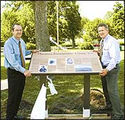 Steve Dunn / Gate City Kirk Brandenberger (left), executive director of the Keokuk Area Convention and Tourism Bureau, and BYU professor Fred Woods stand by the new historic marker in Triangle Park in Keokuk that will be dedicated Saturday afternoon. Woods also is executive director of the Mormon Historic Sites Foundation that paid for new curbs in part of Triangle Park where the marker is located.