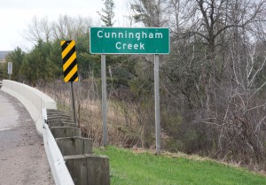 Sign identifying Cunningham Creek where it flows near Neillsville.
