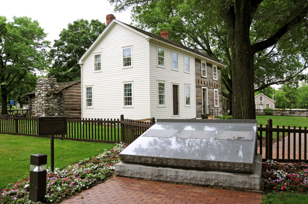 Joseph Smith Homestead with the graves of Joseph, Emma and Hyrum in the foreground. Photo (2008) by Kenneth Mays.