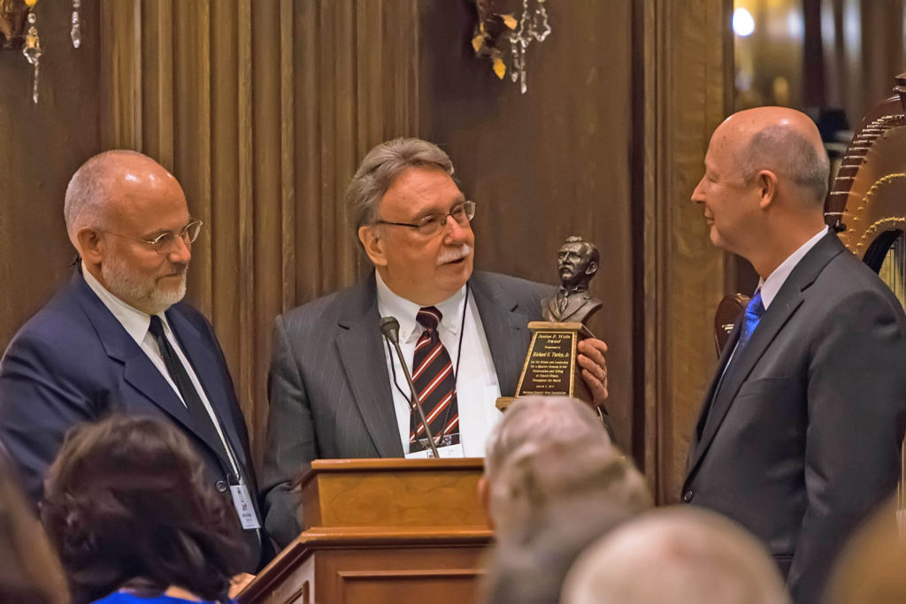 Kim Wilson & Jeffrey Walker presenting the Junius Wells Award to Richard E. Turley, Jr.